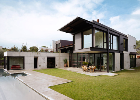 Pivoting steel doors lead into Studio Sitges, a house and photography studio in Spain by Olson Kundig