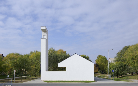 Church congregation hall by SAGRA Architects features a towering white bell tower