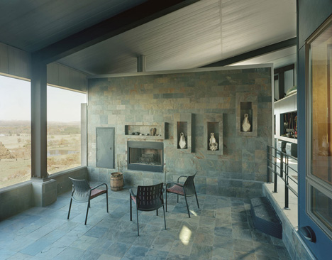 Angular metal roof wraps around a hilltop house by deMx architecture