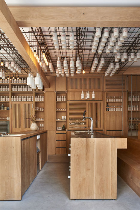 Buero Wagner suspends bottles of foraged ingredients from ceiling of cocktail bar