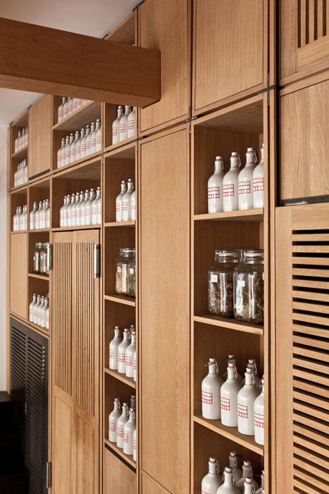 Buero Wagner suspends bottles of foraged ingredients from ceiling of cocktail bar