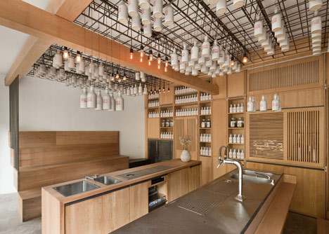 Buero Wagner suspends bottles of foraged ingredients from ceiling of cocktail bar