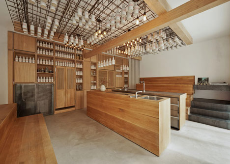 Buero Wagner suspends bottles of foraged ingredients from ceiling of cocktail bar