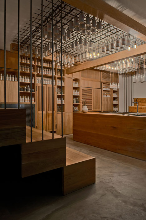 Buero Wagner suspends bottles of foraged ingredients from ceiling of cocktail bar