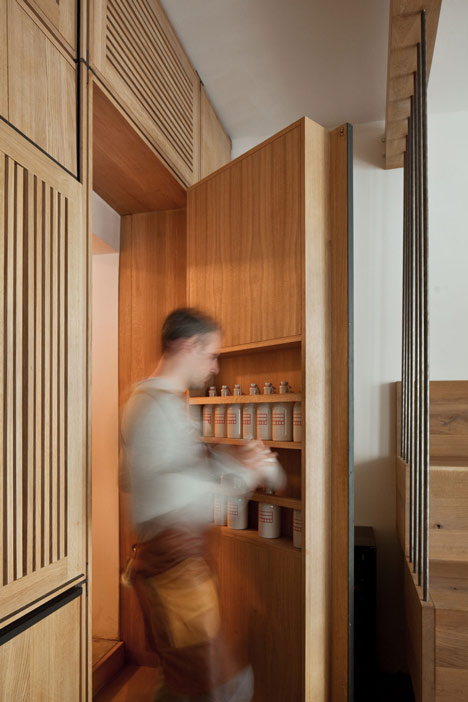 Buero Wagner suspends bottles of foraged ingredients from ceiling of cocktail bar