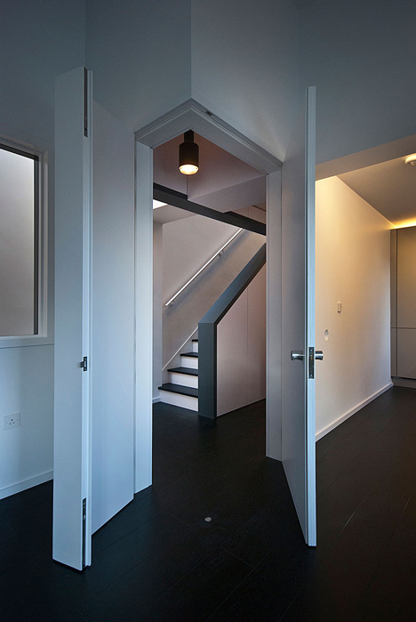 Long staircase spans converted London apartment by PATALAB Architecture