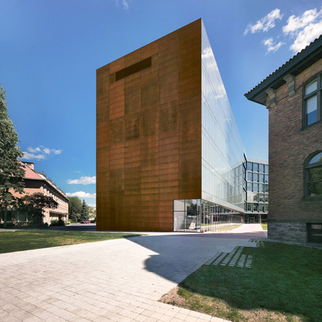 Grand orange staircase ascends through college by Saucier + Perrotte