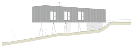 Black-painted S House by Hammerschmid Pachl Seebacher raised up on stilts