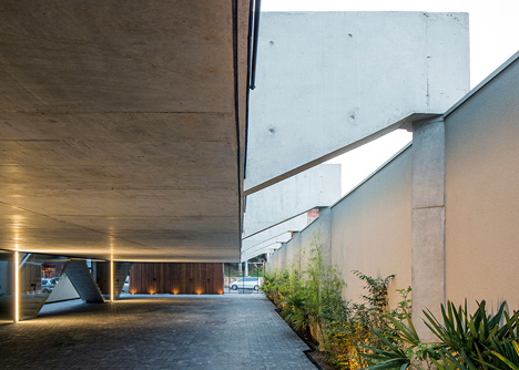 Wall of bushy plants fronts Sao Paulo housing block by TACOA