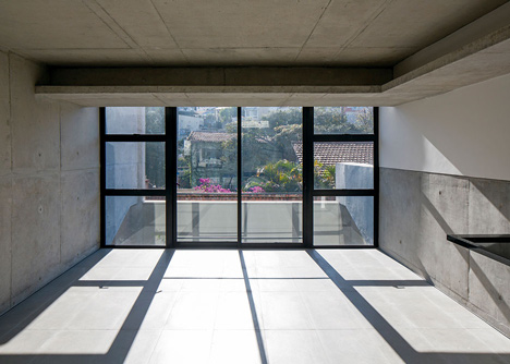 Wall of bushy plants fronts Sao Paulo housing block by TACOA