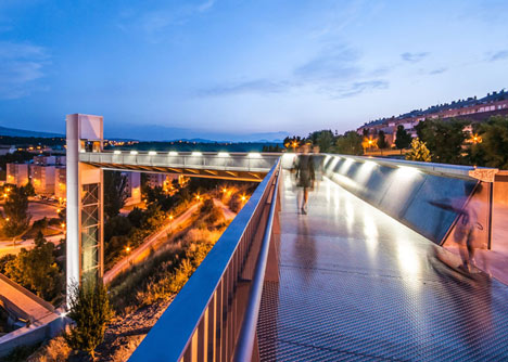 A steel-clad outdoor elevator connects the city and suburb in Pamplona by AH Asociados