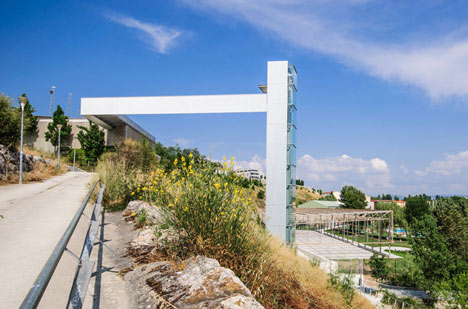A steel-clad outdoor elevator connects the city and suburb in Pamplona by AH Asociados