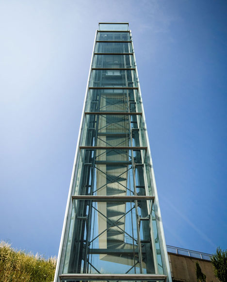 A steel-clad outdoor elevator connects the city and suburb in Pamplona by AH Asociados