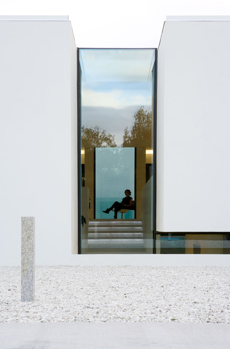 Doorway hidden in volcanic stone wall of B25 house by PK Arkitektar