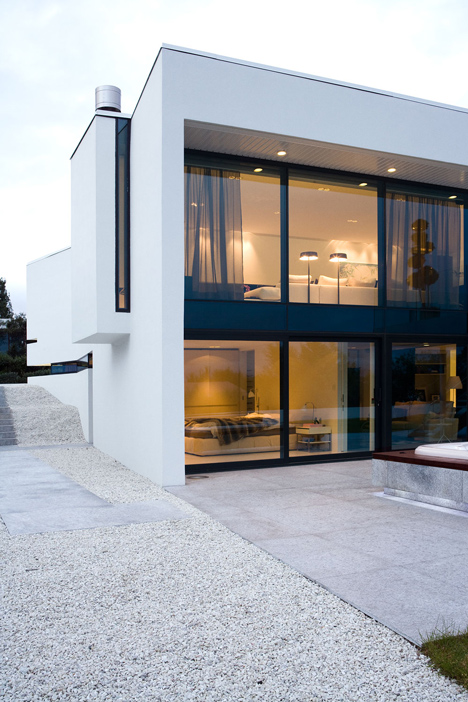 Doorway hidden in volcanic stone wall of B25 house by PK Arkitektar