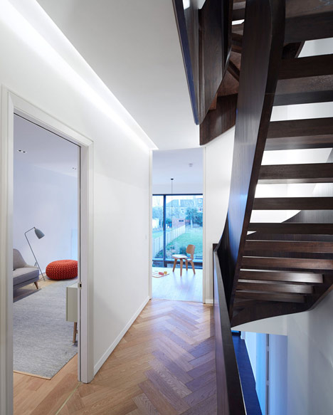 Curvacious oak staircase ascends through converted London convent by John Smart Architects