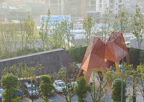 Four-legged perforated metal pavilions rise above Fengming Mountain Park