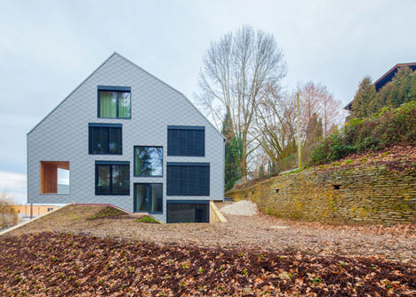 House B.A.B.E. by Destilat features windows dotted across shingle-clad facade