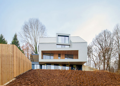 House B.A.B.E. by Destilat features windows dotted across shingle-clad facade