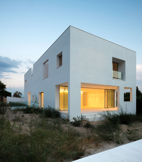 Casa H by Bojaus Arquitectura features a facade covered in holes