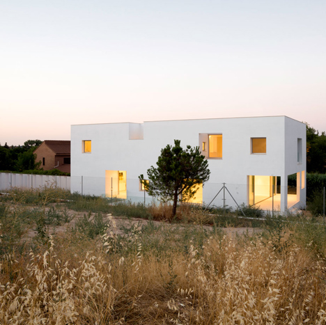 Casa H by Bojaus Arquitectura features a facade covered in holes