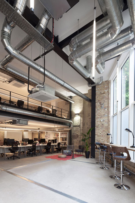 Industrial-style offices by DH Liberty mix reclaimed objects with minimal aesthetic
