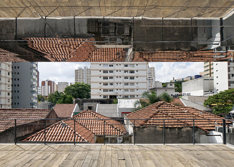 Shiny metal box hovers above shopping and restaurant complex by Triptyque