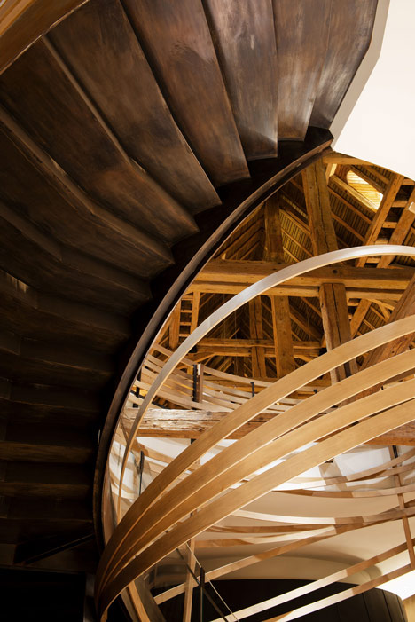 Wooden strips coil around staircase at Strasbourg hotel by Jouin Manku