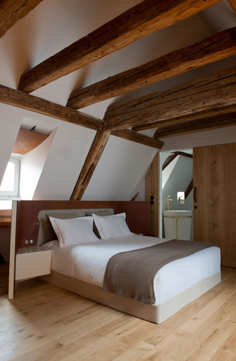 Wooden strips coil around staircase at Strasbourg hotel by Jouin Manku