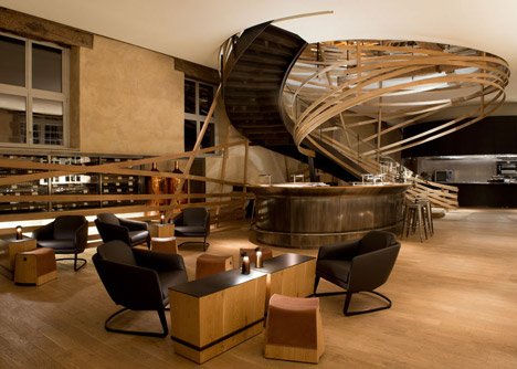 Wooden strips coil around staircase at Strasbourg hotel by Jouin Manku