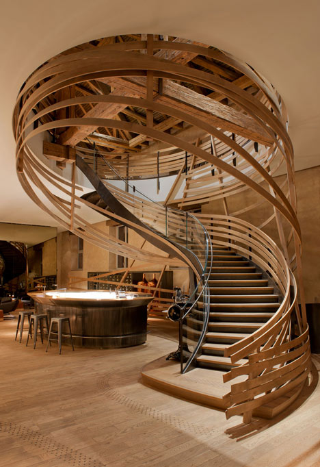 Wooden strips coil around staircase at Strasbourg hotel by Jouin Manku