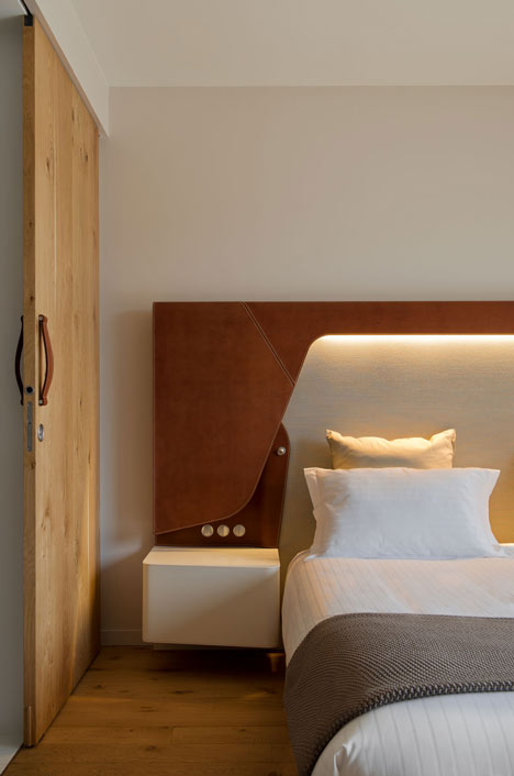 Wooden strips coil around staircase at Strasbourg hotel by Jouin Manku