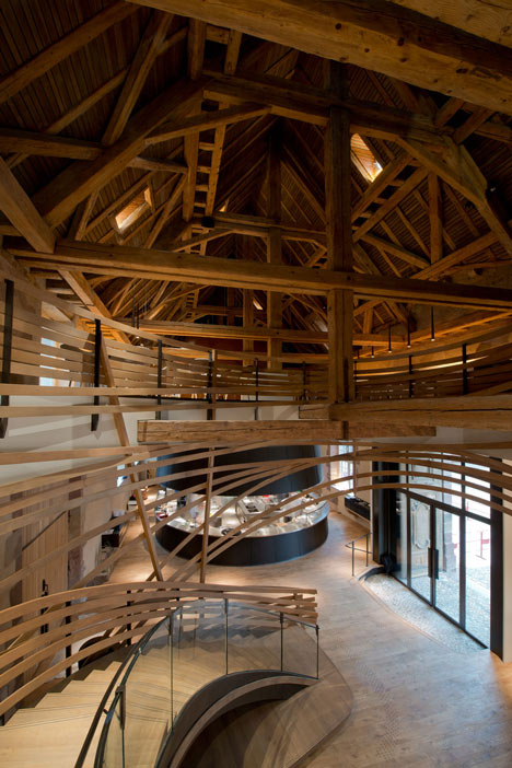 Wooden strips coil around staircase at Strasbourg hotel by Jouin Manku