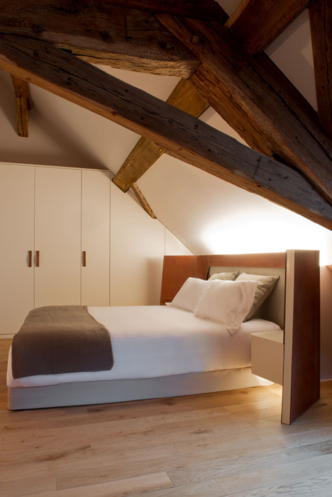 Wooden strips coil around staircase at Strasbourg hotel by Jouin Manku