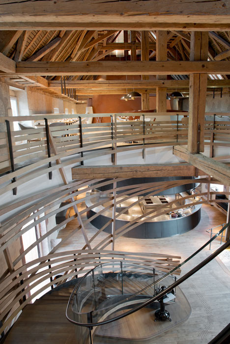 Wooden strips coil around staircase at Strasbourg hotel by Jouin Manku
