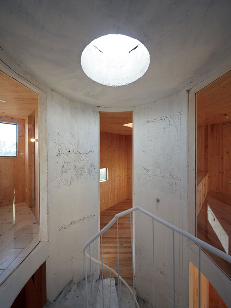 Concrete staircase spirals up through Pezo von Ellrichshausens Casa Gago