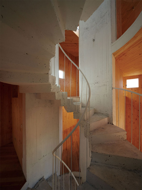 Concrete staircase spirals up through Pezo von Ellrichshausens Casa Gago