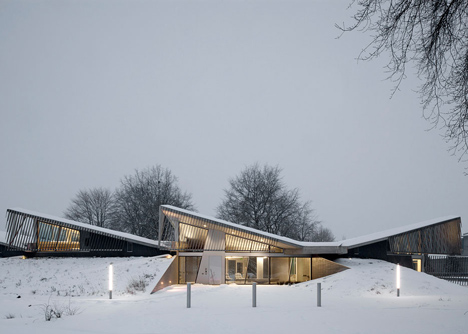 Water treatment facility by Skylab Architecture features a roof of grass-covered fins