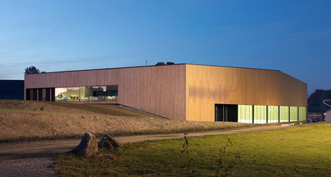 Timber walls feature narrow vertical slices at Virdis Architecture's Lussy Sports Hall