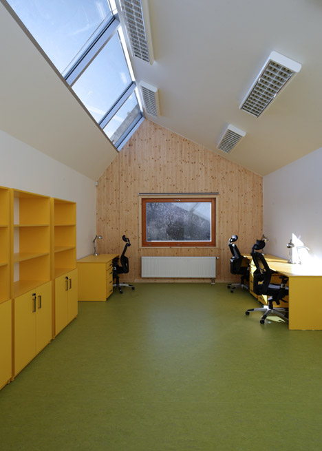 3+1 Architekti converts a stone barn into a woodwork facility with a serrated timber extension