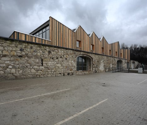 3+1 Architekti converts a stone barn into a woodwork facility with a serrated timber extension