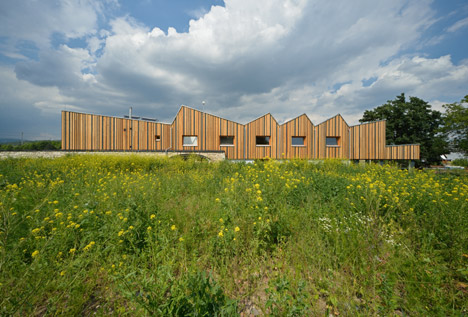 3+1 Architekti converts a stone barn into a woodwork facility with a serrated timber extension