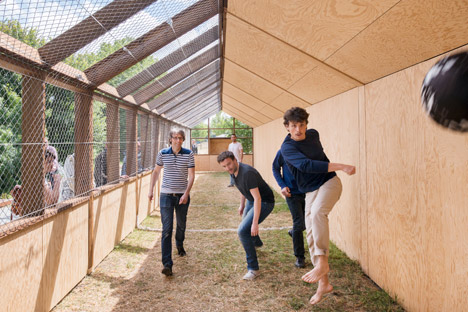 Guinée*Potin Architectes creates "footcheball" playground inside a thatched shed