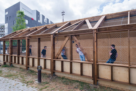Guinée*Potin Architectes creates "footcheball" playground inside a thatched shed