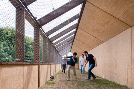 Guinée*Potin Architectes creates "footcheball" playground inside a thatched shed