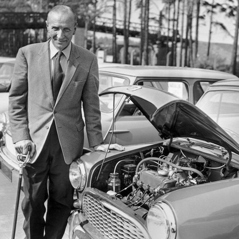 MINI designer Alec Issigonis standing next to his creation