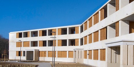 Social housing with solid stone walls by Perraudin Architecture