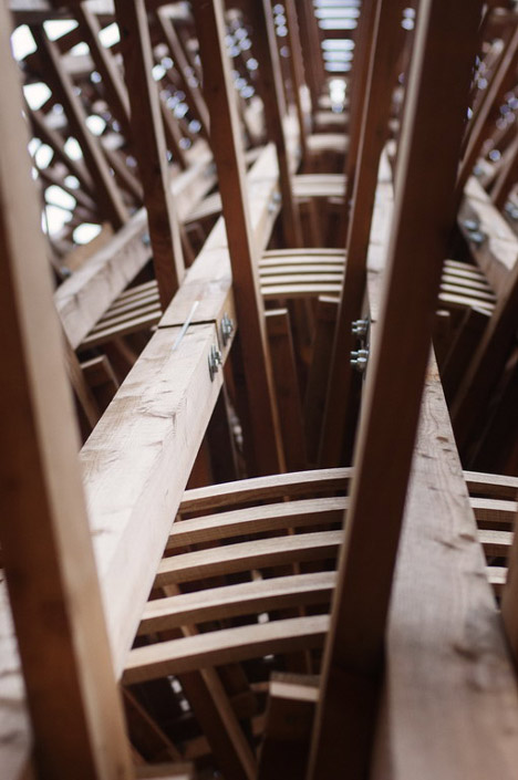 Timber observation tower shaped like a cucumber by Mjölk Architekti