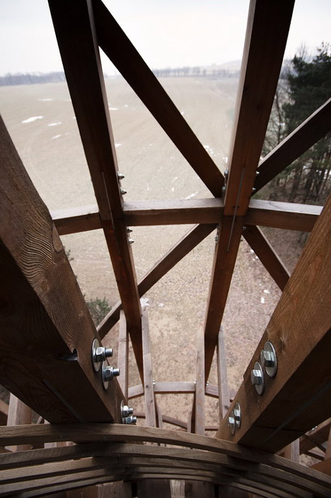 Timber observation tower shaped like a cucumber by Mjölk Architekti