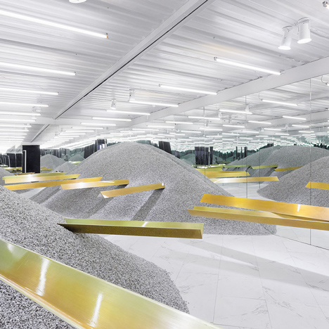 Golden girders protrude from piles of gravel to display sunglasses